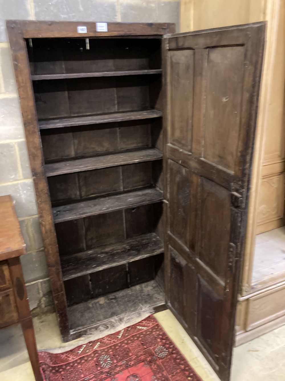 An 18th century panelled oak cupboard, width 74cm depth 30cm height 166cm